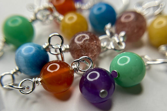 A mix of colored gemstones in long sterling dangle earrings