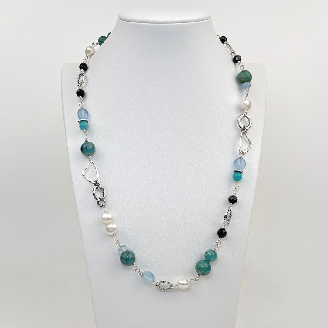 Matisse Blues 21 inch sterling necklace with aquamarine, amazonite, black tourmaline, and pearls shown on neck display