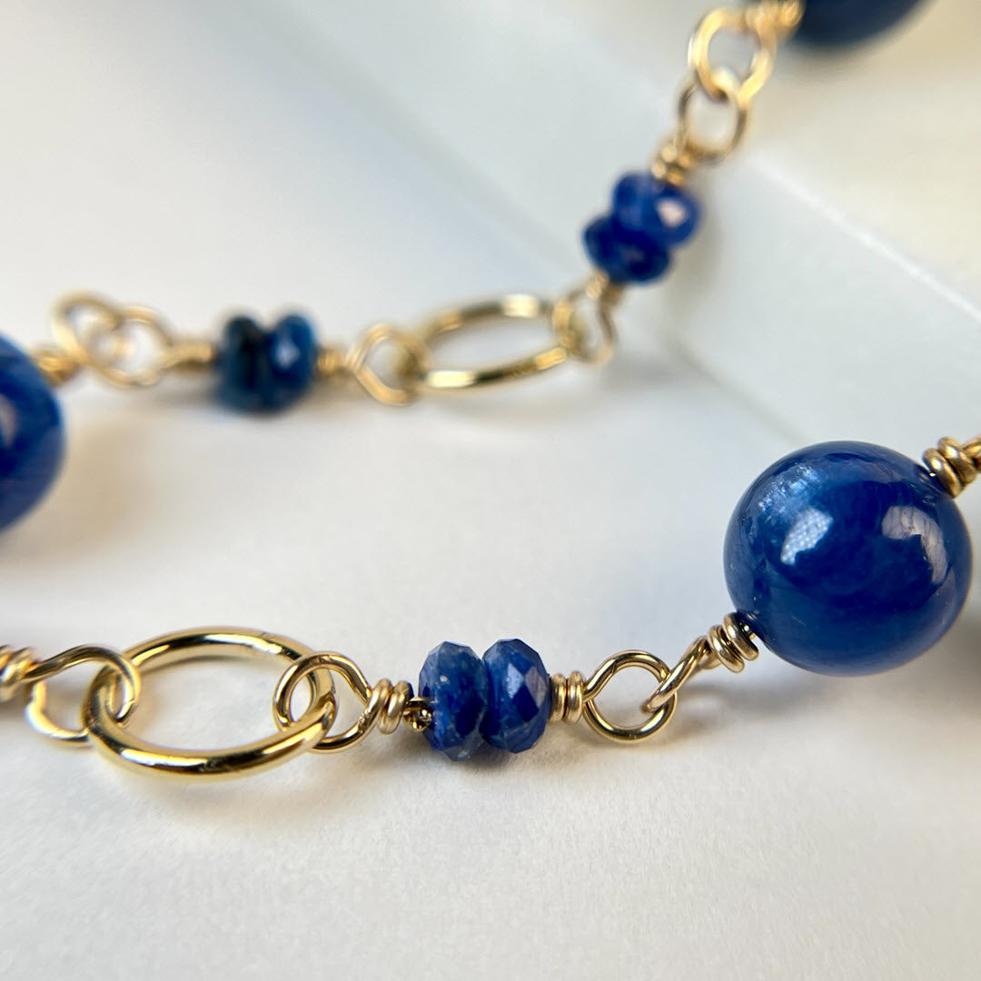 Closeup of 14K gold fill and deep blue kyanite round gemstone link necklace