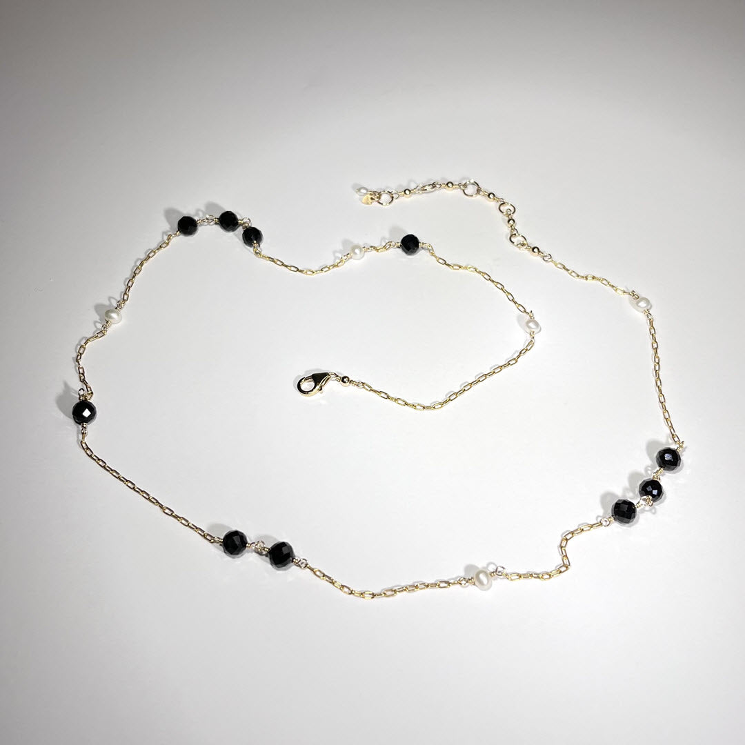 Asymmetrical station necklace of 14K gold fill chain and black tourmaline and white freshwater pearls 