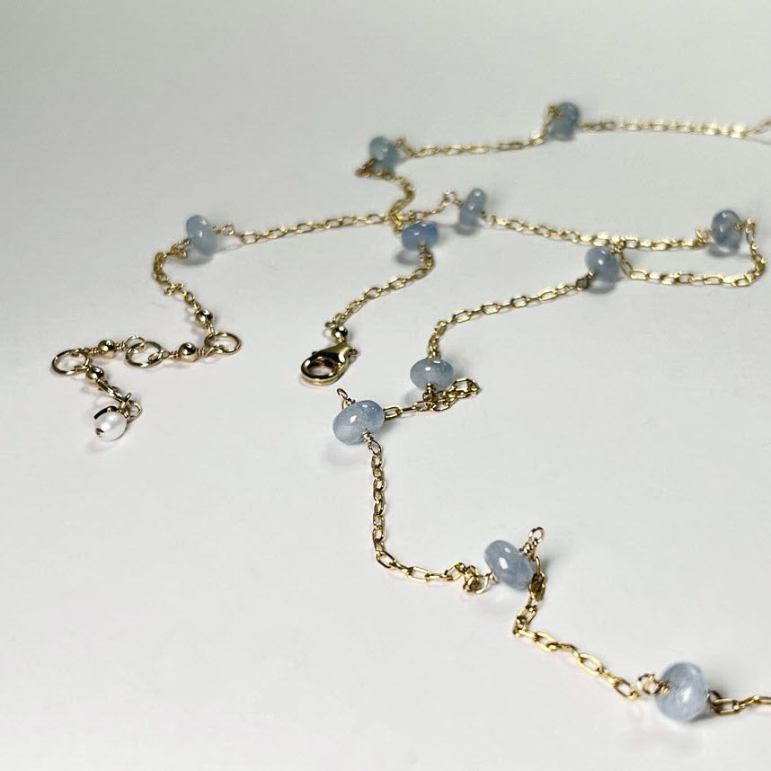 Station necklace with 19 light blue aquamarine gemstones on long 14K gold fill chain